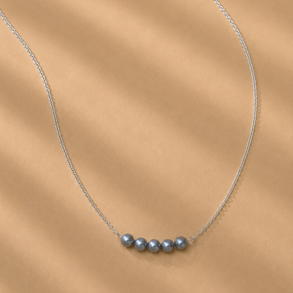 The Vivienne Necklace by Ryā Atelier featuring 5 blue-toned freshwater pearls on a delicate sterling silver belcher chain. 