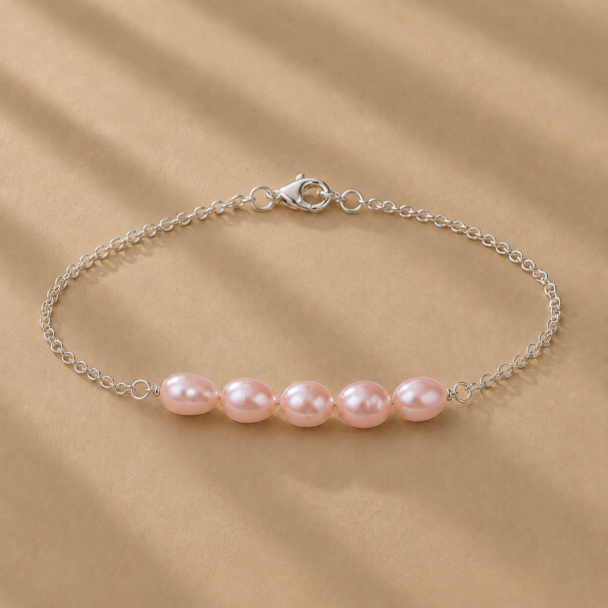 The Vivienne Bracelet by Ryã Atelier, featuring five natural pink-toned freshwater pearls on a delicate 925 sterling silver chain. Individually made in South Africa.