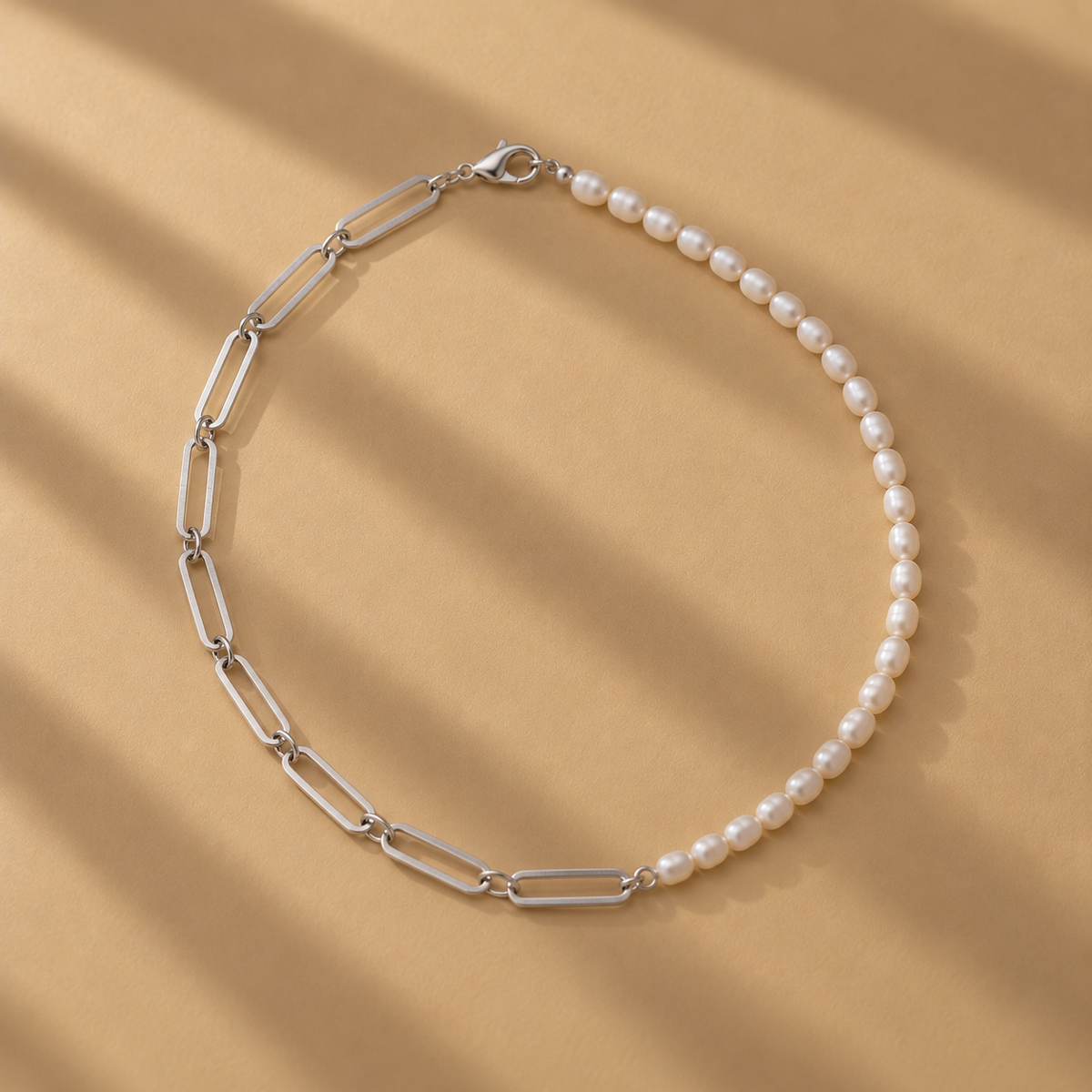 The Ayanda Necklace by Ryā Atelier features a solid sterling silver handmade paperclip chain and a string of delicate freshwater pearls. 