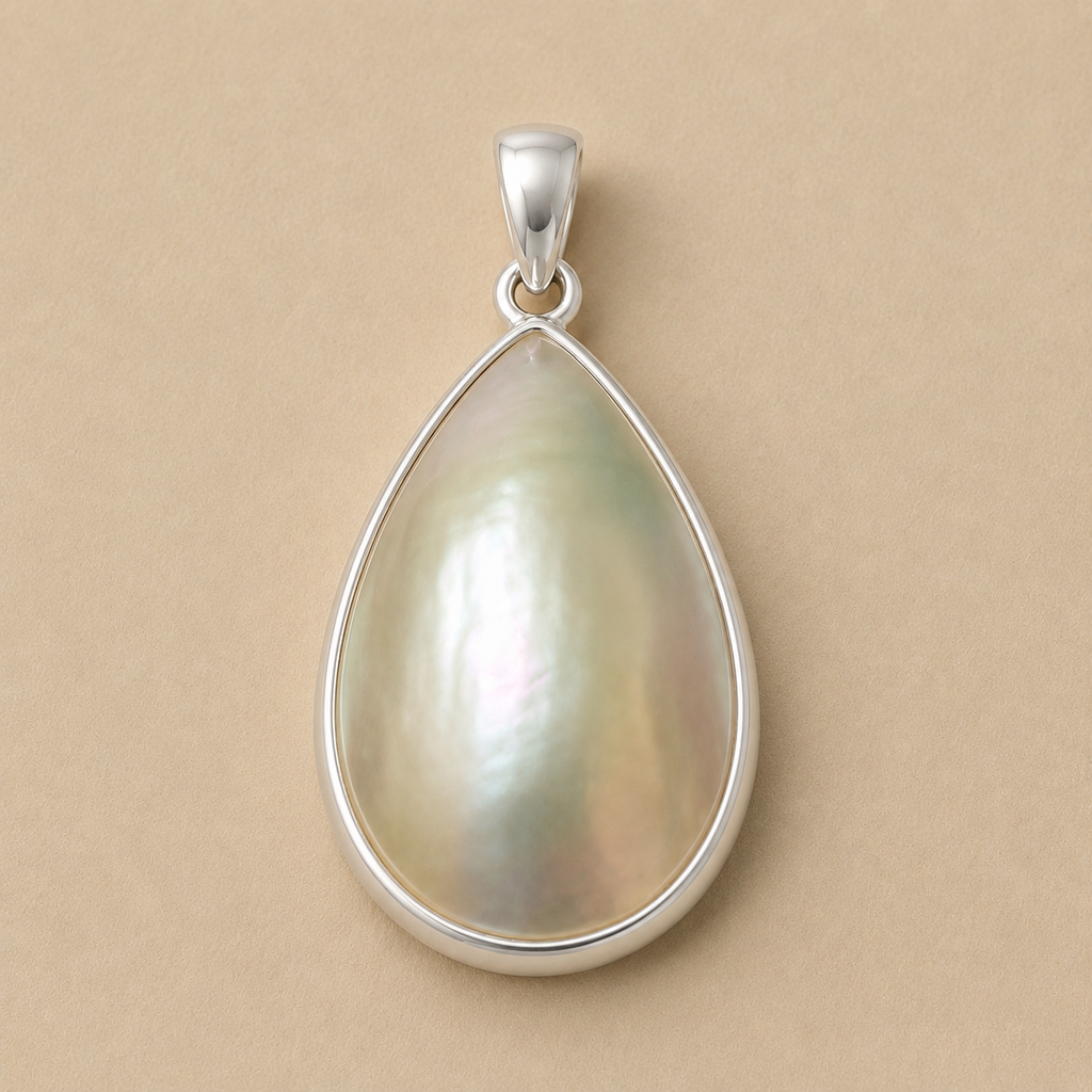 The inyembezi pendant from Ryā Atelier features a teardrop-shaped mabe pearl set in a solid sterling silver bezel