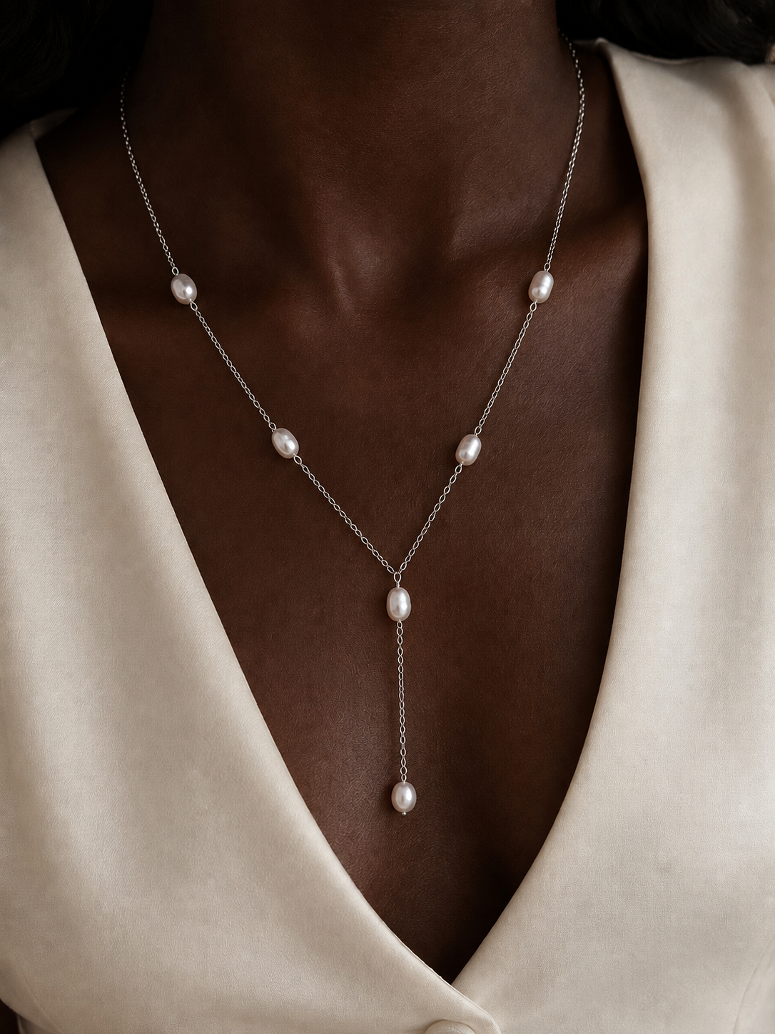 Model wearing the Ryã Atelier Nubia Necklace with 6mm freshwater pearls spaced along a sterling silver chain and pearl drop