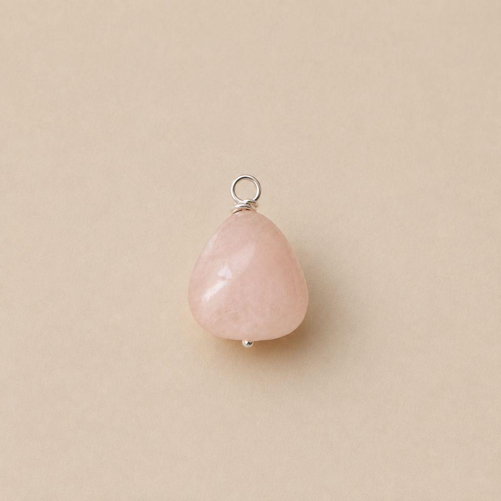 Rosa Pendant handcrafted from a natural Rose Quartz drop bead with a sterling silver ball head pin and round pendant loop on Ryã Atelier's signature oatmeal background.