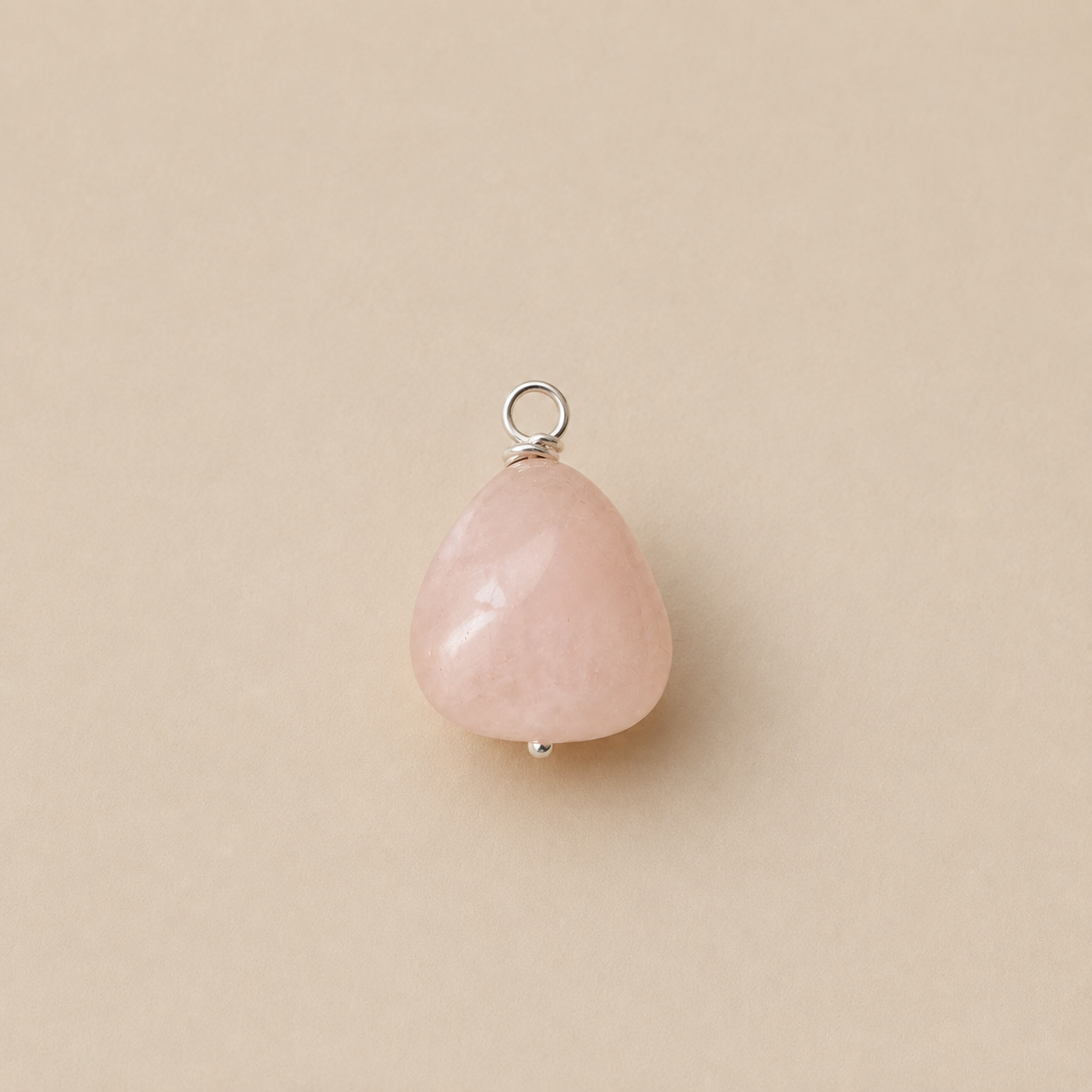 Rosa Pendant handcrafted from a natural Rose Quartz drop bead with a sterling silver ball head pin and round pendant loop on Ryã Atelier's signature oatmeal background.