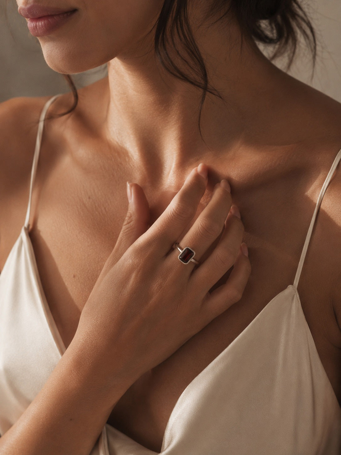 Model wearing the Amahle Ring handcrafted in solid 925 sterling silver with a natural emerald cut garnet by Ryã Atelier.