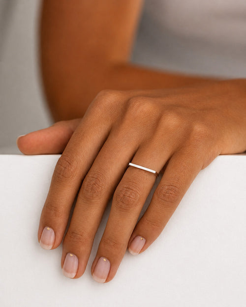 Close up of Model wearing the Amina Ring handcrafted in solid 925 sterling silver with a contemporary geometric straight top design by Ryã Atelier.