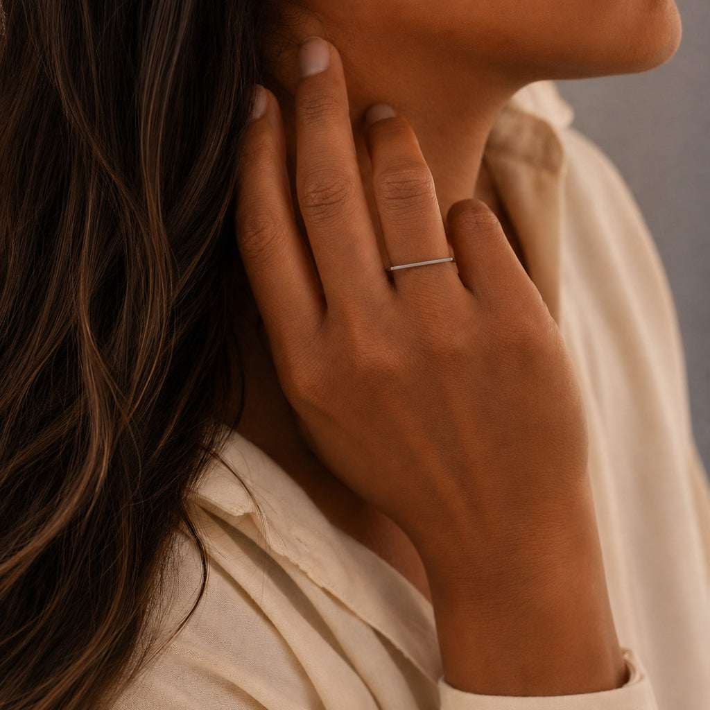 close up of Model's hand wearing the Amina Ring handcrafted in solid 925 sterling silver with a contemporary geometric straight top design by Ryã Atelier.