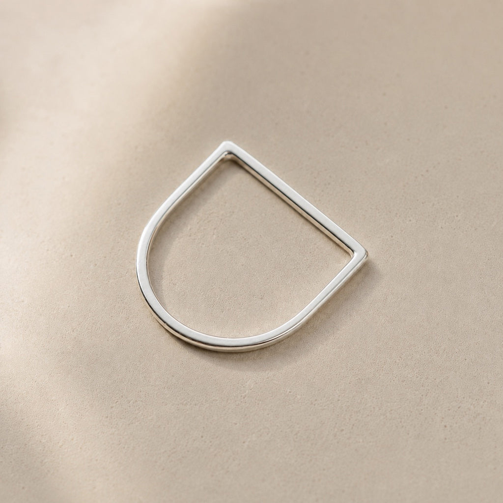 Amina Ring handcrafted in solid 925 sterling silver featuring a minimalist geometric straight top design by Ryã Atelier, on a beige background. 