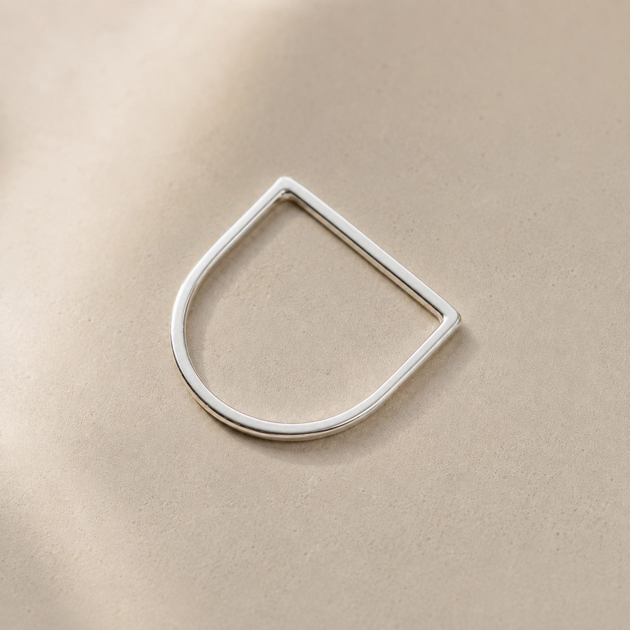 Amina Ring handcrafted in solid 925 sterling silver featuring a minimalist geometric straight top design by Ryã Atelier, on a beige background. 