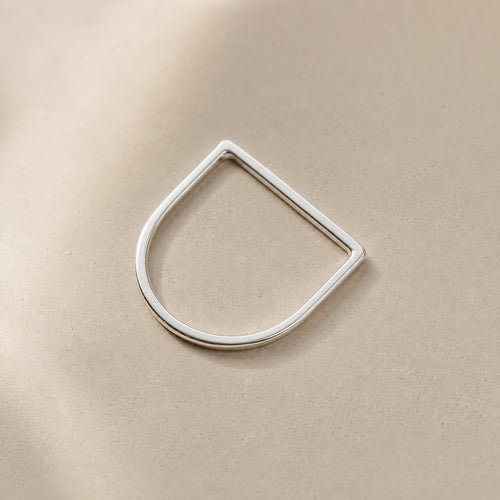 Amina Ring handcrafted in solid 925 sterling silver featuring a minimalist geometric straight top design by Ryã Atelier, on a beige background. 