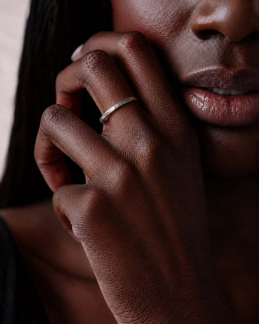 close up of models hand wearing the Asanda Thick Ring handcrafted in solid 925 sterling silver featuring a hand-hammered faceted stacking band by Ryã Atelier.
