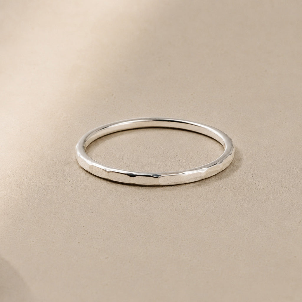 Asanda Thin Ring handcrafted in solid 925 sterling silver featuring a minimalist hand-hammered faceted stacking band by Ryã Atelier.