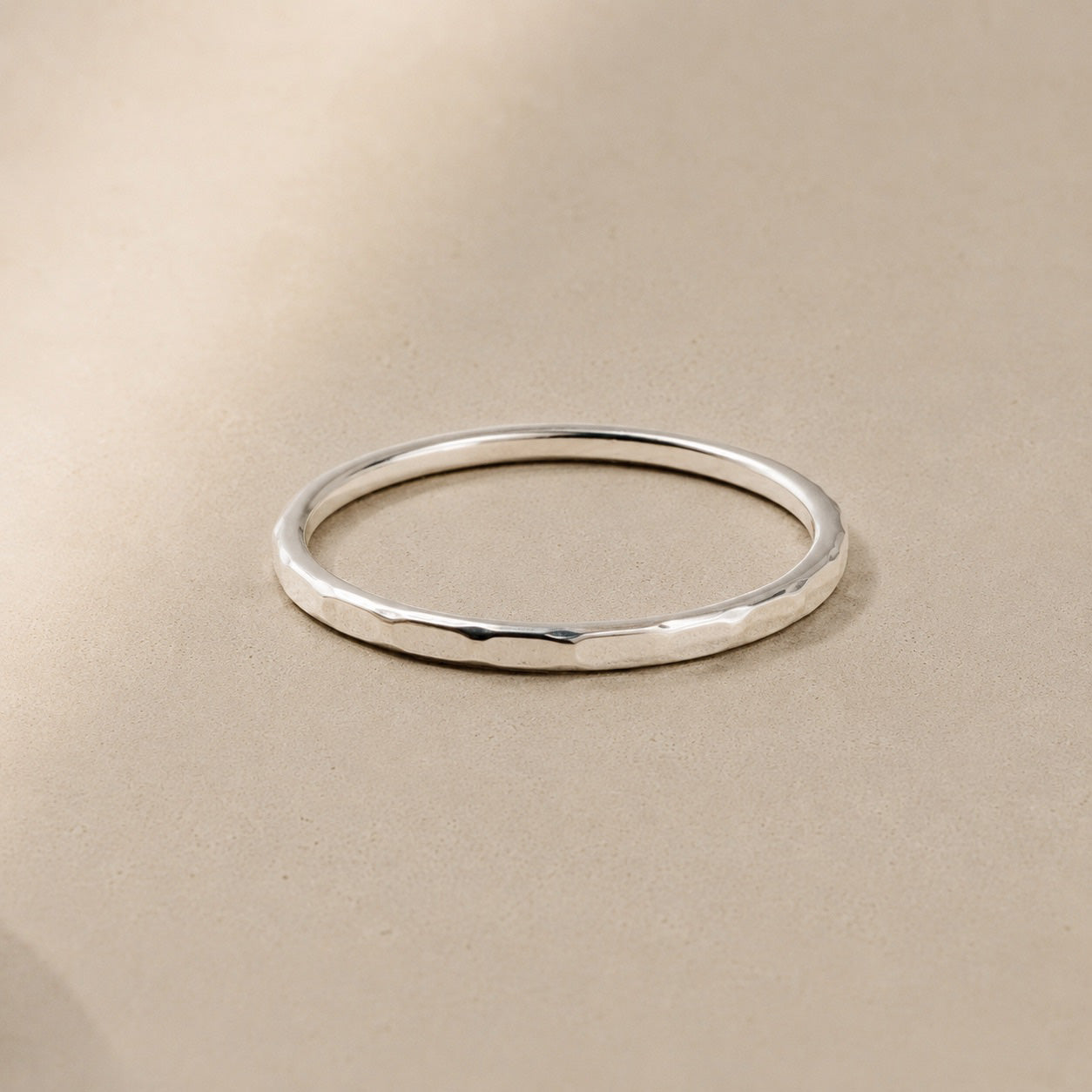 Asanda Thin Ring handcrafted in solid 925 sterling silver featuring a minimalist hand-hammered faceted stacking band by Ryã Atelier.