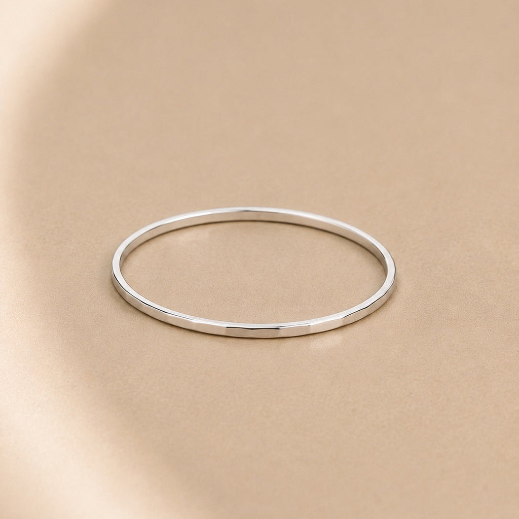 Asanda Thin Ring handcrafted in solid 925 sterling silver featuring a minimalist hand-hammered faceted stacking band by Ryã Atelier.