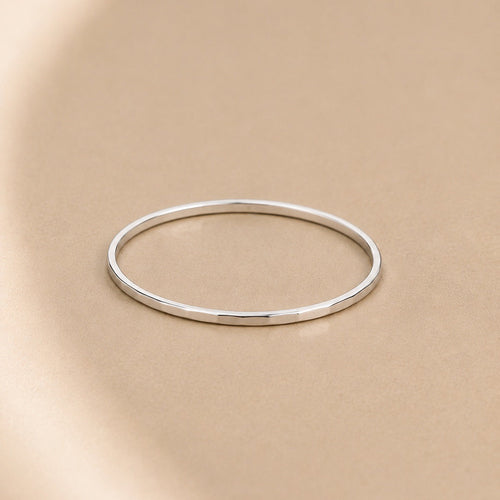 Asanda Thin Ring handcrafted in solid 925 sterling silver featuring a minimalist hand-hammered faceted stacking band by Ryã Atelier.
