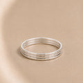 Three Asanda Thin Rings handcrafted in solid 925 sterling silver with hand-hammered faceted bands by Ryã Atelier.