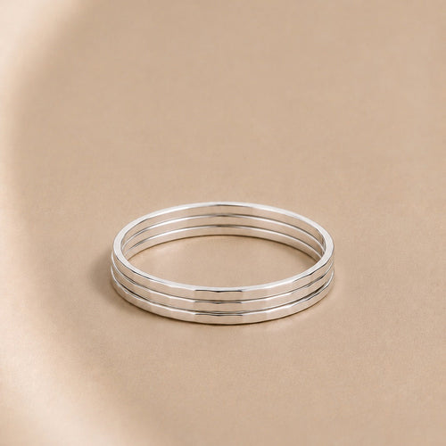 Three Asanda Thin Rings handcrafted in solid 925 sterling silver with hand-hammered faceted bands by Ryã Atelier.