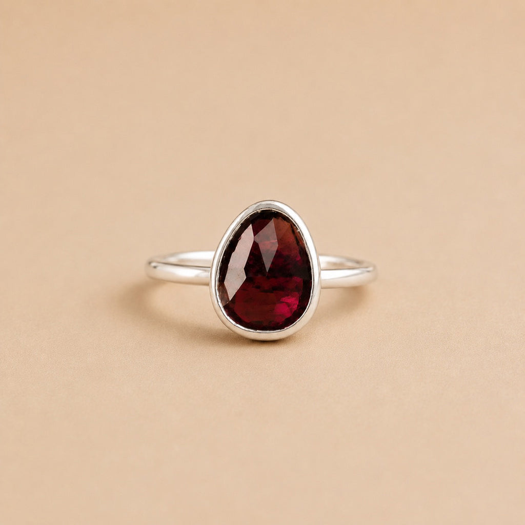 Avethandwa Ring handcrafted in solid 925 sterling silver featuring a natural pear-shaped garnet in a bezel setting by Ryã Atelier.