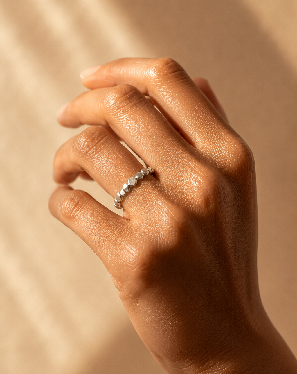 close up of Models hand wearing the Emihle Ring handcrafted in solid 925 sterling silver with an organic pebble design by Ryã Atelier.