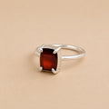 Holly Ring handcrafted in solid 925 sterling silver featuring a natural emerald cut garnet in a contemporary four-claw setting by Ryã Atelier.
