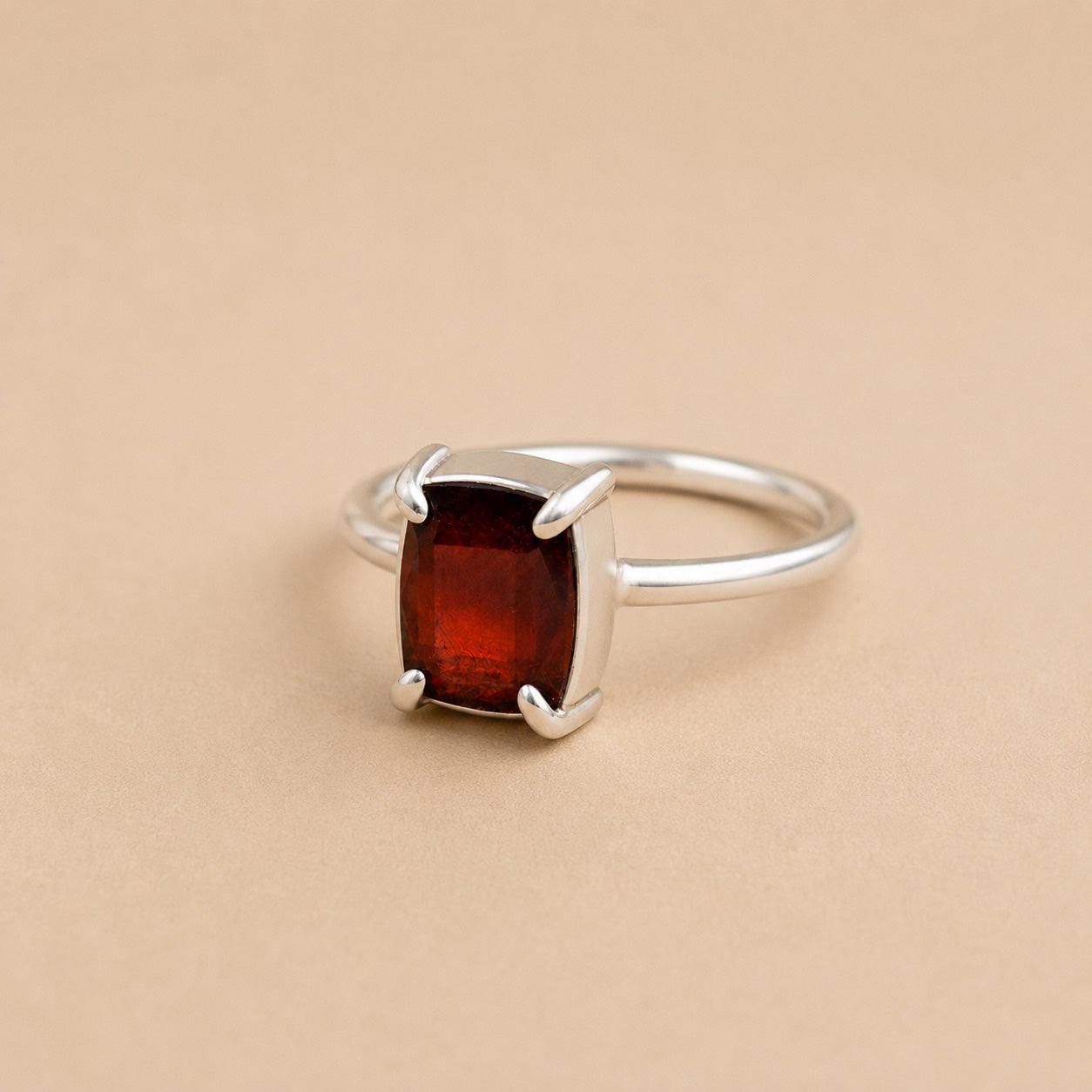 Holly Ring handcrafted in solid 925 sterling silver featuring a natural emerald cut garnet in a contemporary four-claw setting by Ryã Atelier.