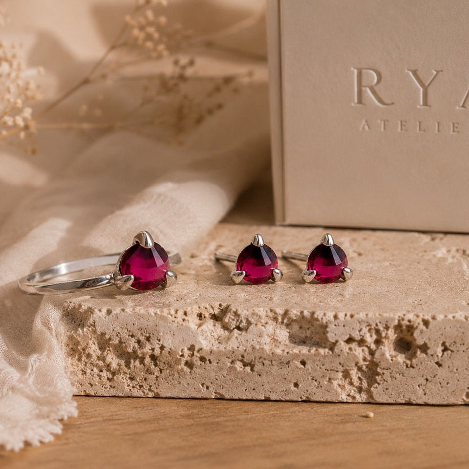 Natural Garnet ring and earrings set, set in sterling silver on a stone surface with 'RYA ATELIER' box in the background
