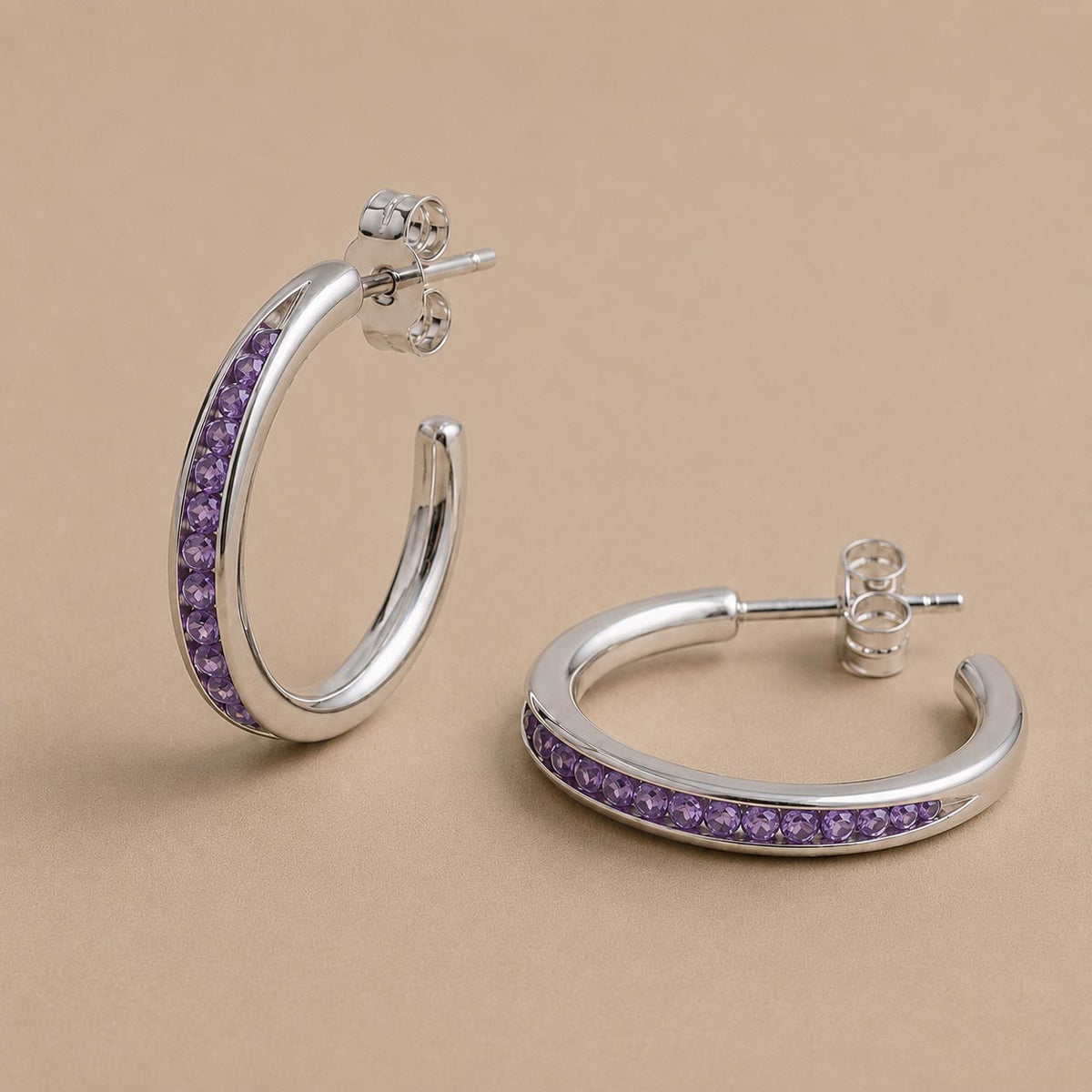 The Izimbewu Amethyst Seed Earrings by Rya Atelier. Amethyst gemstone beads set in a steling silver seed pod setting. 