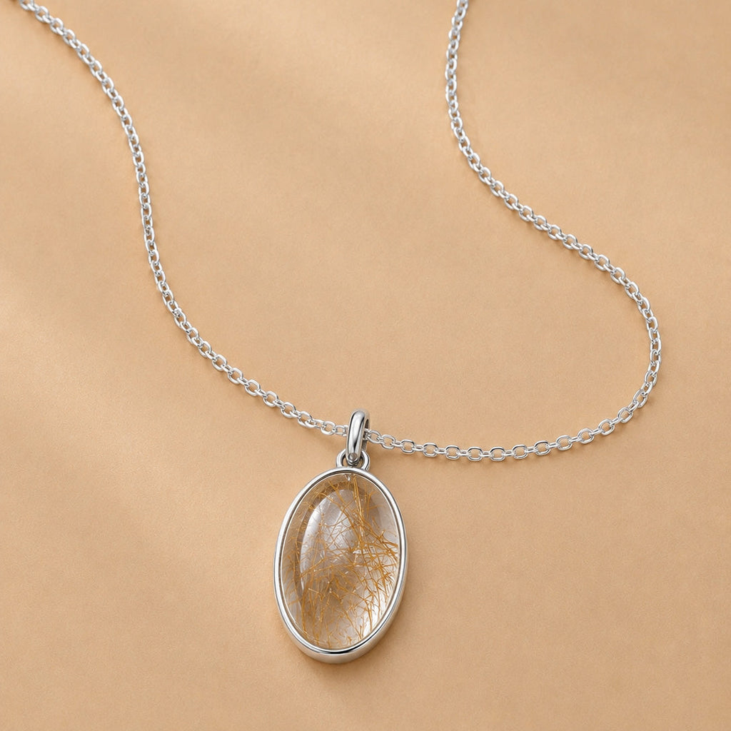Sterling Silver necklace with a natural gold rutilated quartz pendant on a beige background