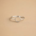 Sterling Silver ring with a circular design on a beige background