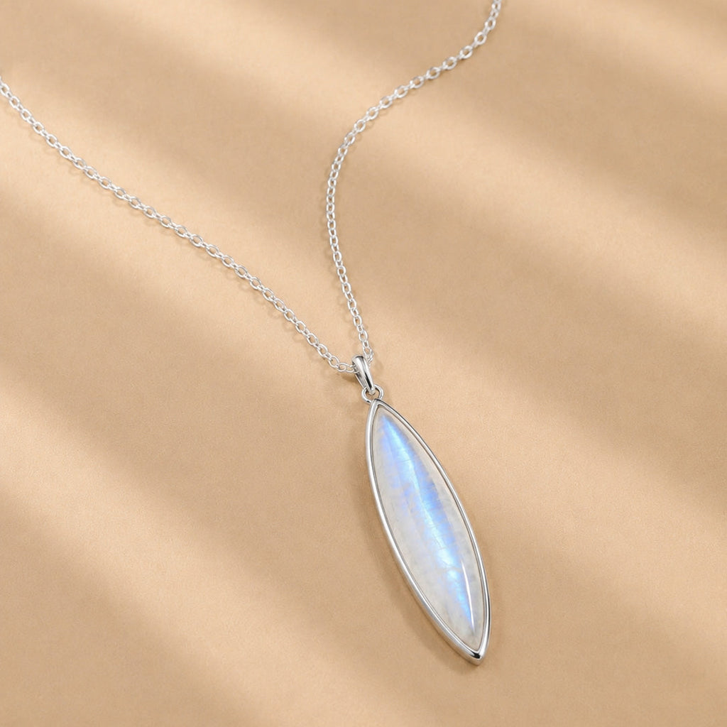 Sterling Silver necklace with a marquise-shaped natural moonstone pendant on a beige background