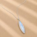 Sterling Silver necklace with a marquise-shaped natural moonstone pendant on a beige background
