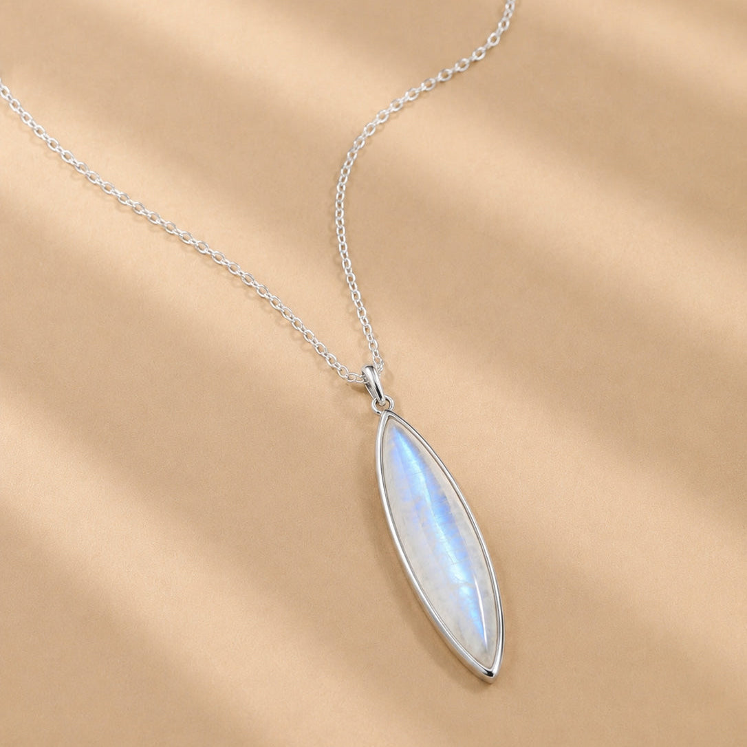 Sterling Silver necklace with a marquise-shaped natural moonstone pendant on a beige background