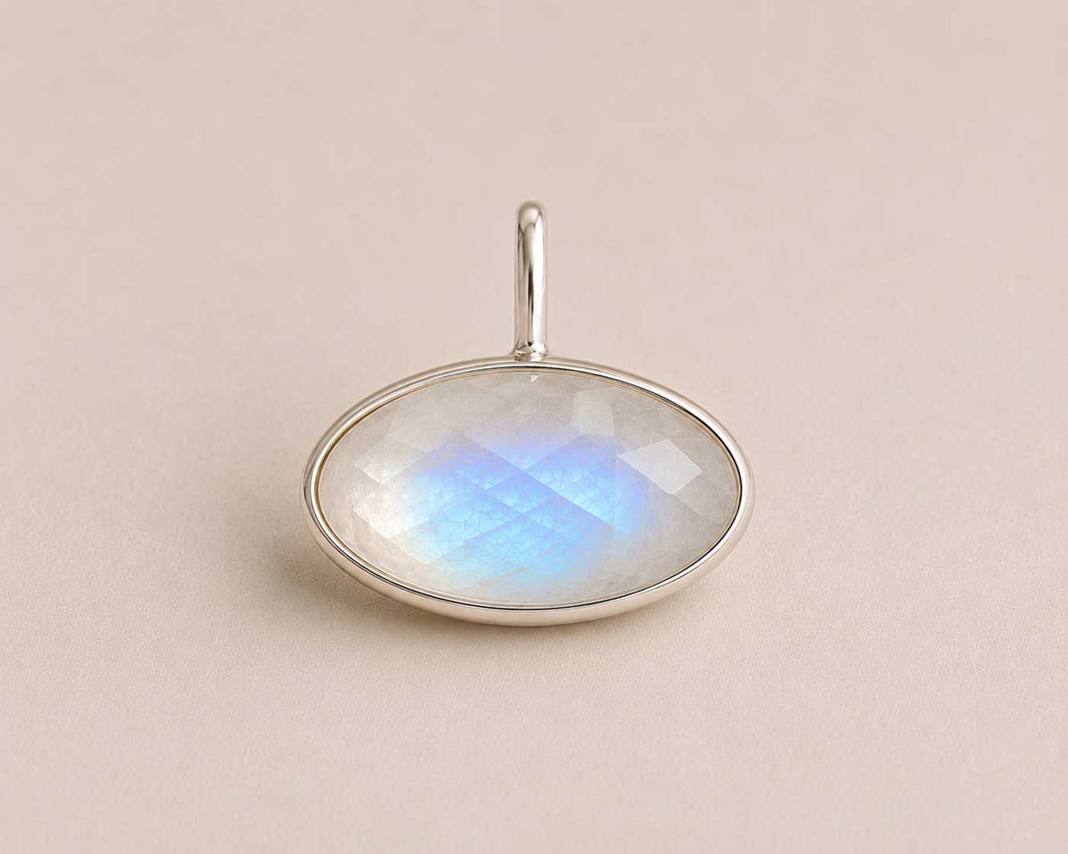Elipse shaped Unyezi Moonstone pendant by Rya Atelier. Faceted Rainbow Moonstone set in solid 925 sterling silver. 