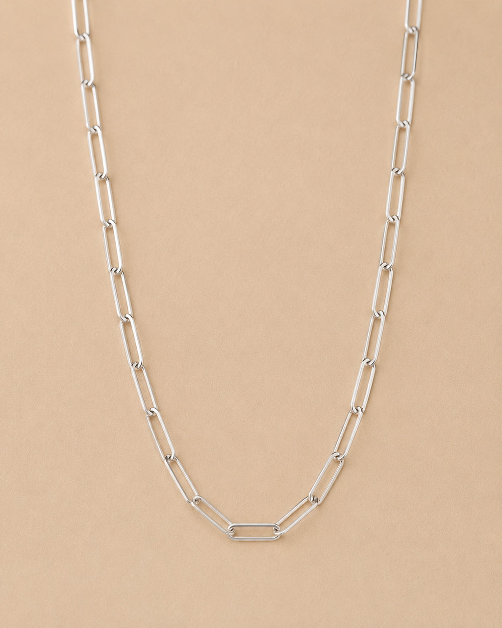 Handcrafted Sterling Silver paperclip chain necklace on a beige background