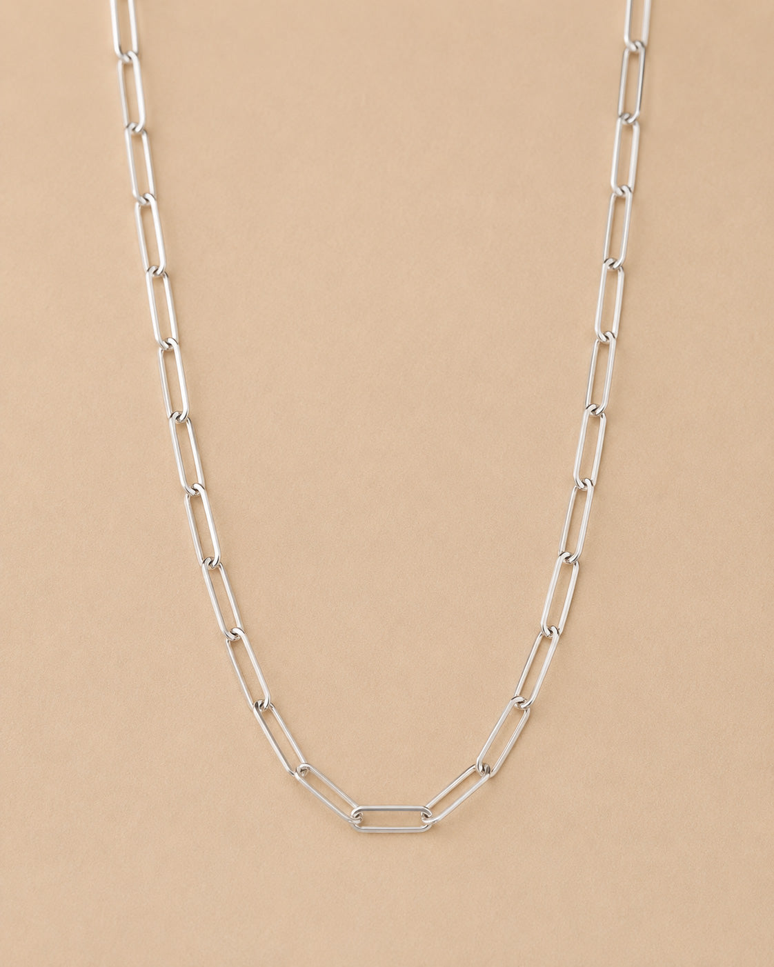 Handcrafted Sterling Silver paperclip chain necklace on a beige background