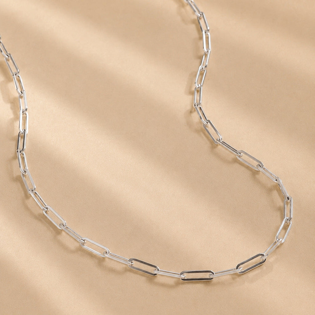 handcrafted solid 925 Sterling Silver paperclip chain necklace on a beige background