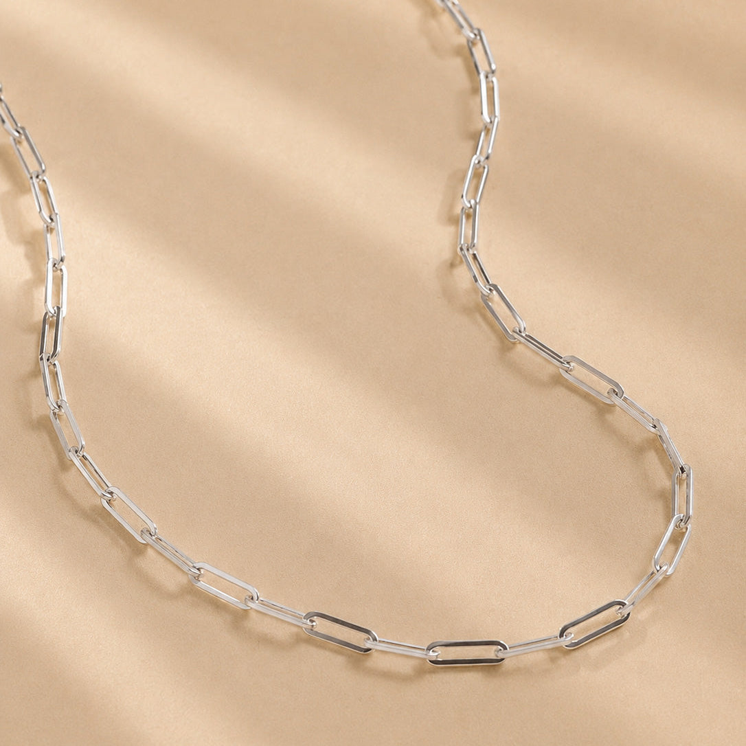 handcrafted solid 925 Sterling Silver paperclip chain necklace on a beige background