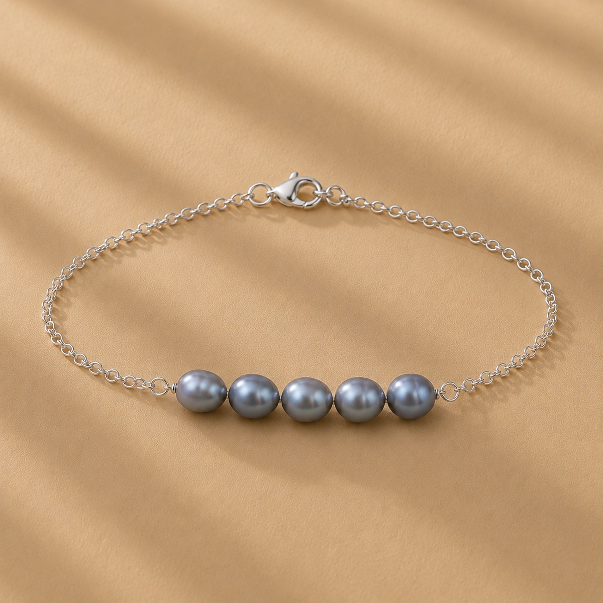 The Vivienne Blue Pearl Bracelet by Ryã Atelier, featuring five blue-toned natural freshwater pearls on a delicate 925 sterling silver chain. Individually made in South Africa.