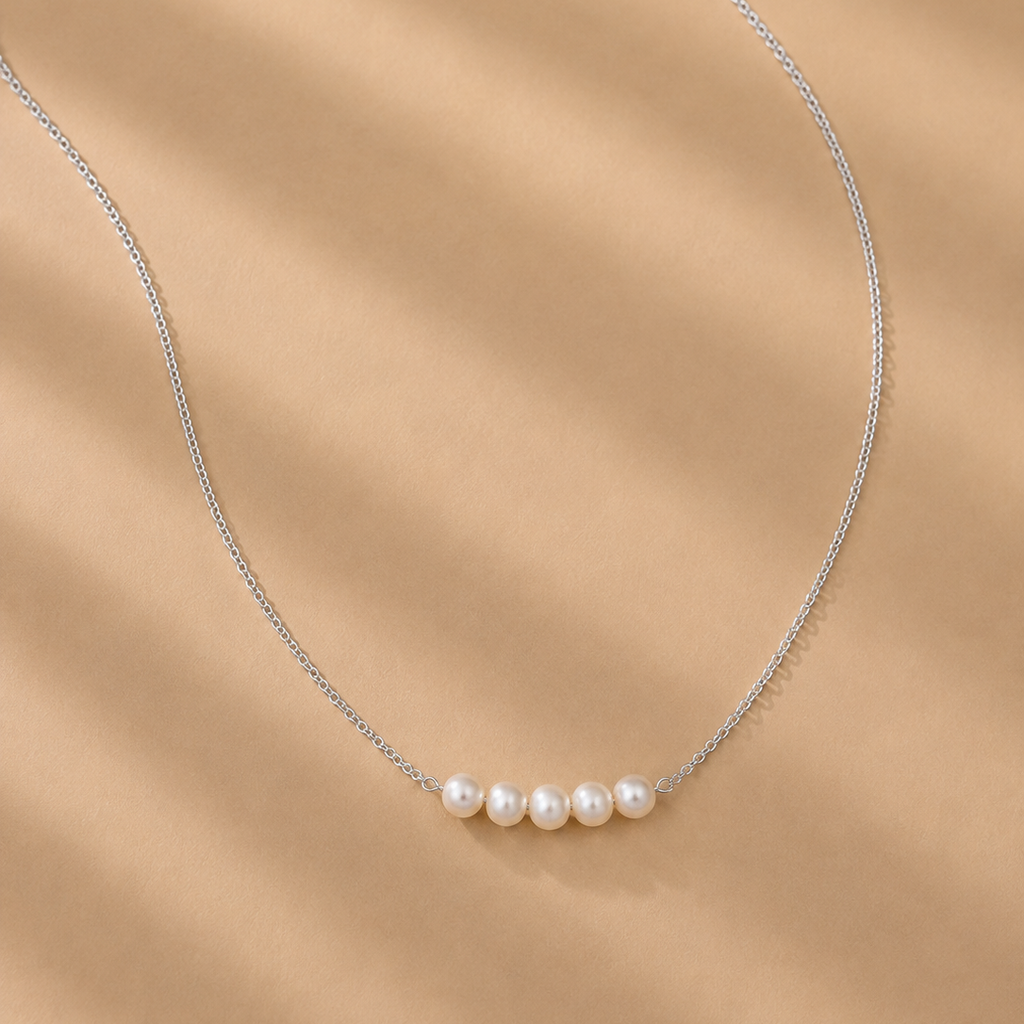 Vivienne White Pearl Necklace by Ryã Atelier with five white 5mm freshwater pearls on a sterling silver chain