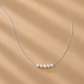 Vivienne White Pearl Necklace by Ryã Atelier with five white 5mm freshwater pearls on a sterling silver chain