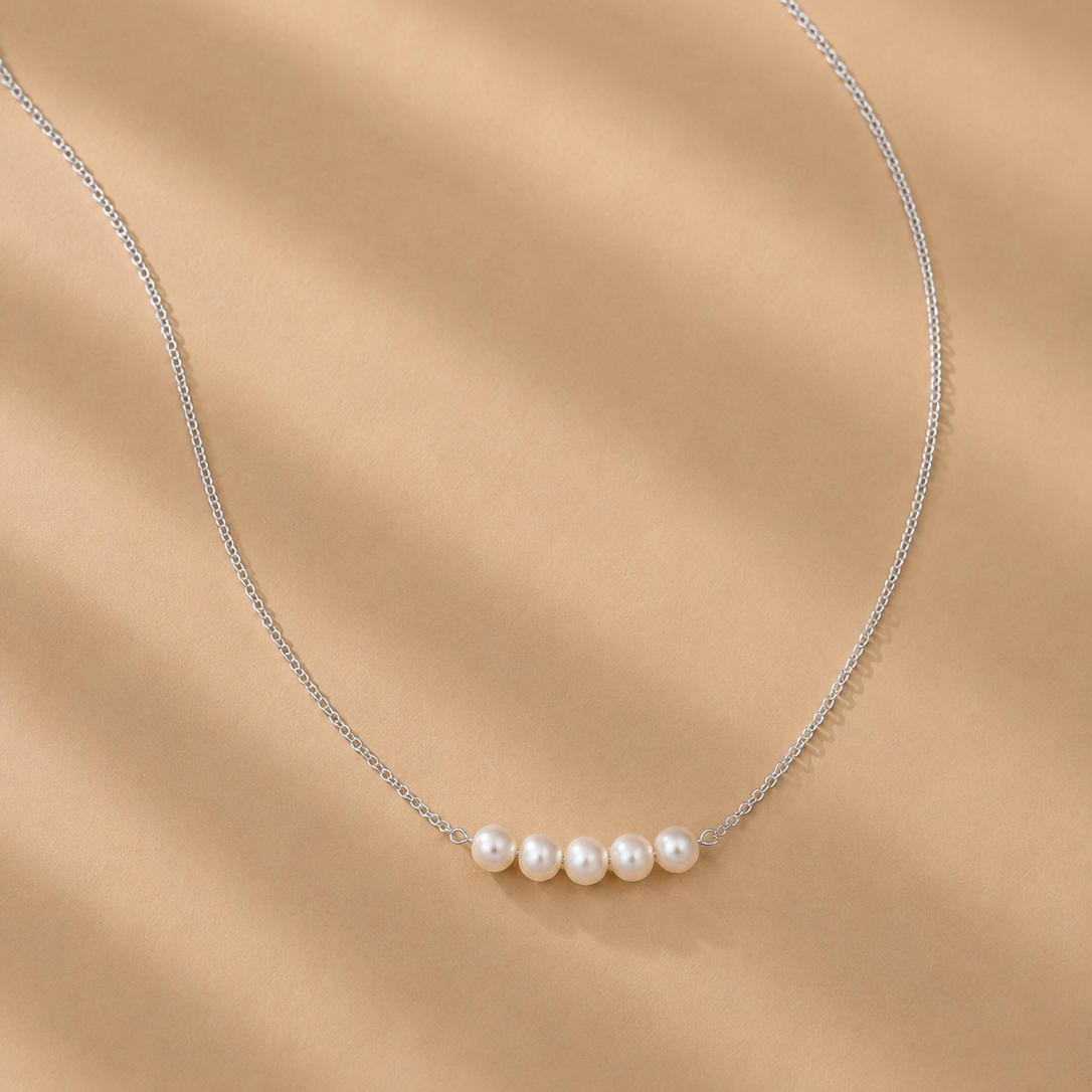 Vivienne White Pearl Necklace by Ryã Atelier with five white 5mm freshwater pearls on a sterling silver chain