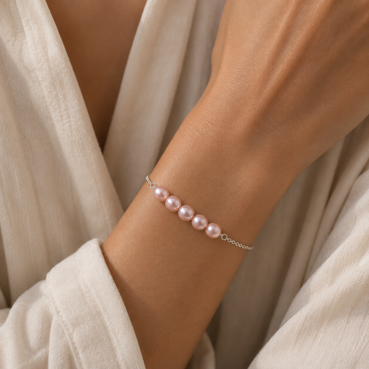Model wearing the Vivienne pink pearl Bracelet by Ryã Atelier, featuring five natural pink-toned freshwater pearls on a delicate 925 sterling silver chain. Individually made in South Africa.