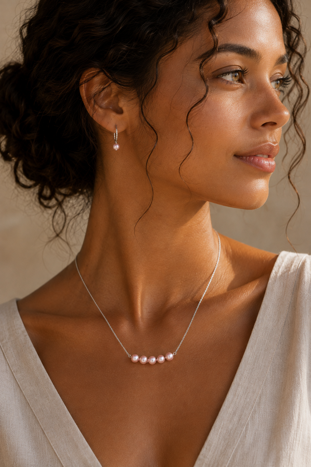 Model wearing the Ryã Atelier Vivienne Pink Pearl Necklace with five 5mm pink-toned freshwater pearls on a sterling silver chain